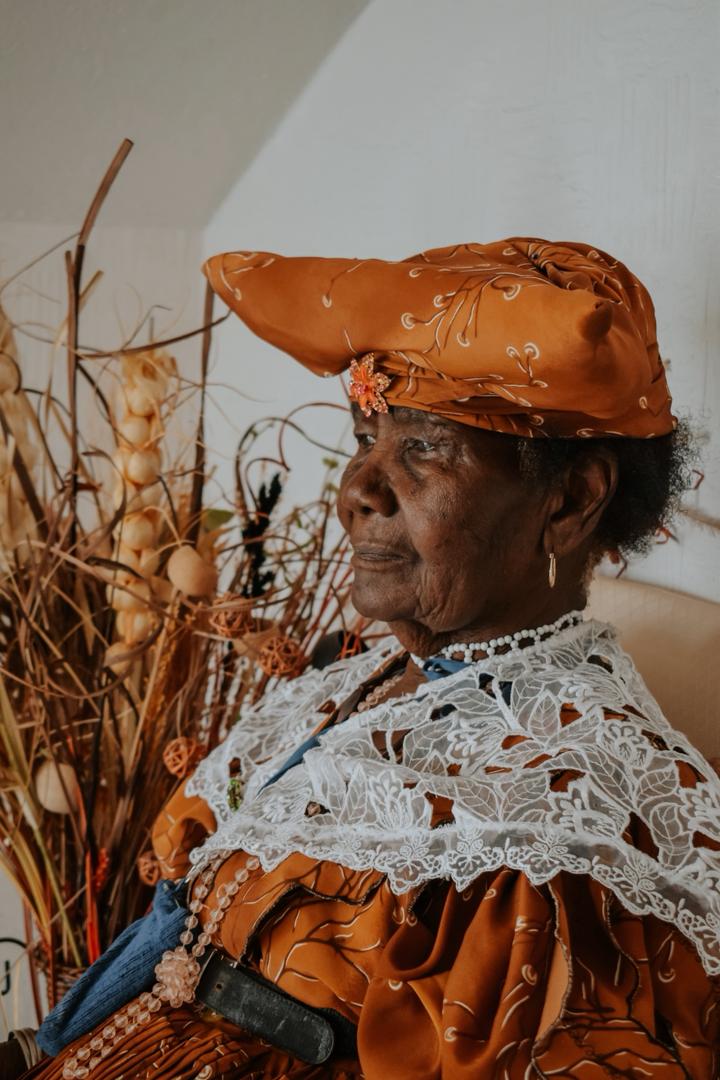 A close-up, dramatic portrait of a woman with her hair blowing